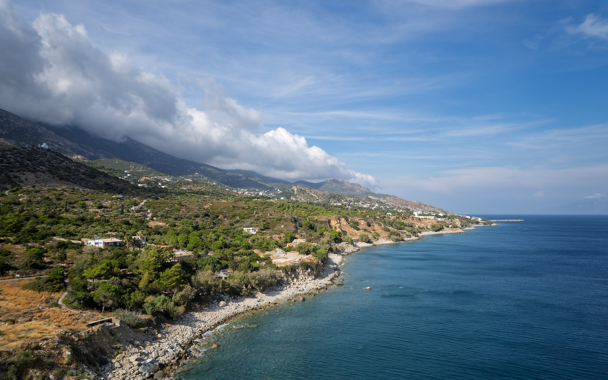The coastline of Ikaria, Greece, falling into the open Aegean